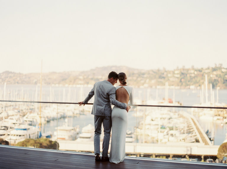 Wedding couple overlooking harbor